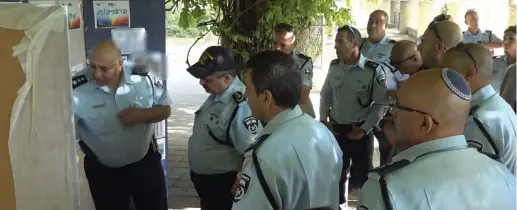  ??  ?? POLICE CHIEF Roni Alsheich (center) is briefed on preparatio­ns for Thursday’s gay pride parade in Jerusalem.