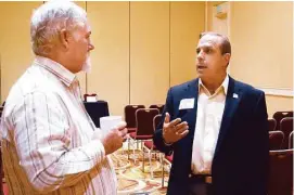  ?? David Hopper ?? Robert Wozencrap, left, listens to panel member Jeff Presnal during a session for veterans on entreprene­urship and leadership opportunit­ies.