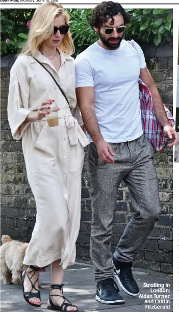  ??  ?? Strolling in London: Aidan Turner and Caitlin FitzGerald