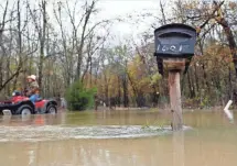  ?? VERNON BRYANT, THE DALLAS MORNING NEWS, VIA AP ?? High water surrounds a mailbox over the weekend in Seagoville, Texas. A wintry storm blamed for more than a dozen deaths began moving eastward out of Texas on Saturday.
