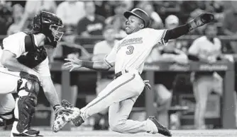  ?? LINDSEY WASSON/GETTY IMAGES ?? Cedric Mullins of the Orioles beats the throw to David Freitas of the Mariners in the seventh inning Tuesday.