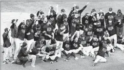  ?? NAM Y. HUH/AP ?? The Marlins celebrate after defeating the Cubs in Game 2 on Friday.