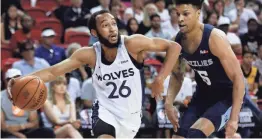  ??  ?? The Timberwolv­es' Jordan Mclaughlin (26) drives around the Grizzlies' Brandon Clarke during the first half of an NBA summer league game Monday in Las Vegas. JOHN LOCHER / AP