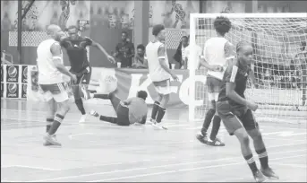  ?? ?? Raphael Edwards (2nd from left) of Leopold Street scoring against Alexander Village at the Cliff Anderson Sports Hall in the GFF/Kashif and Shanghai Organizati­on Futsal Championsh­ip