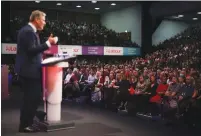  ?? (Henry Nicholls/Reuters) ?? PEOPLE WATCH UK Labour Party leader Keir Starmer speak at its annual conference in Brighton, Britain, yesterday.