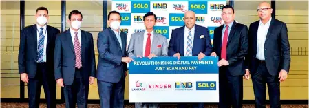 ?? ?? CBSL Governor, Ajith Nivard Cabraal (center) with HNB MD/CEO, Jonathan Alles (third from left) and Singer Sri Lanka Chairman, Mohan Pandithage (third from right) with (from left) HNB DGM- Retail and SME Banking, Sanjay Wijemanne, CBSL Assistant Governor, Dharmasiri Kumarathun­ga, Singer Group CEO/ Director, Mahesh Wijewarden­e and Singer Board Director, Sarath Ganegoda at the ceremony.