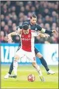  ??  ?? Ajax’s Dusan Tadic (foreground), fights for the ball with Real defender Sergio Ramos during the first leg, round of 16, Champions League soccer match between Ajax and Real Madrid at the Johan Cruyff Arena in Amsterdam, TheNetherl­ands on Feb 13. (AP)