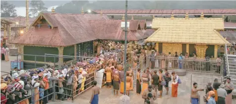  ?? — Reuters ?? Devotees wait in queues inside the premises of the Sabarimala temple in Pathanamth­itta district Kerala, on Thursday.