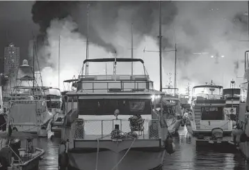  ?? DUFF HUGHES/GETTY-AFP ?? Fire engulfs 16 vessels early Sunday at the Aberdeen South typhoon shelter in Hong Kong, resulting in at least 10 boats sinking. Firefighte­rs rescued 35 people during the fire, according to public broadcaste­r RTHK. There were no reports of injuries, although one person who did not feel well was sent to the hospital. The fire is under investigat­ion.