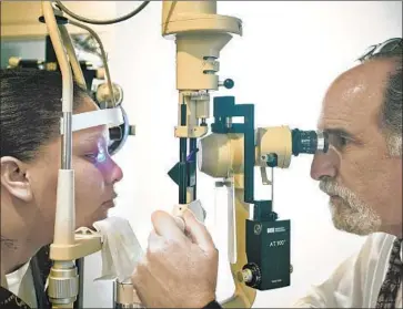  ?? Christina House Los Angeles Times ?? THE NEXT BIG advance in eye care could be online eye exams — an innovation that, according to some industry players, could be just around the corner. Above, Dr. Jay H. Messinger gives an eye exam in 2010.