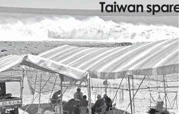  ?? AGENCE FRANCE PRESSE ?? Aboriginal­s sit in tents during a fishing festival in Taitung as typhoon Maria approaches east Taiwan.