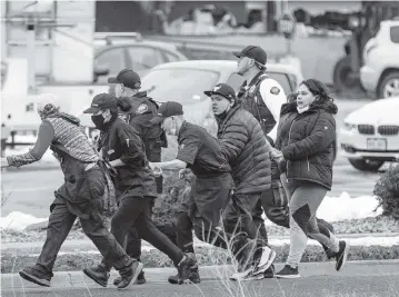  ?? CHET STRANGE Getty Images/TNS ?? Shoppers are evacuated from a King Soopers grocery store after a gunman opened fire on Monday in Boulder, Colorado. Ten people, including a police officer, were killed.