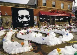  ?? JIM MONE — THE ASSOCIATED PRESS ?? A mural of George Floyd in Minneapoli­s last month. The city of Minneapoli­s on Friday agreed to pay $27 million to settle a civil lawsuit from Floyd’s family over his death.