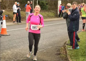  ??  ?? Geraldine O’Loughlin finishes the race in Clonhaston on Sunday.