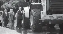  ?? TOM BRENNER / THE NEW YORK TIMES ?? President Donald Trump and Vice President Mike Pence look at a front-end loader made by Caterpilla­r during a Made In America product showcase event July 17, 2017, on the South Lawn of the White House. After years of layoffs and plant closings, things...