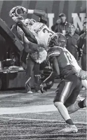  ?? THE ASSOCIATED PRESS ?? Memphis wide receiver Anthony Miller catches a pass over Tulane safety P.J. Hall (16) for a touchdown Friday in Memphis.