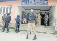  ?? ANI ?? Security forces at a government office in Budgam where Kashmiri Pandit
Rahul Bhat (left) was killed on Thursday.