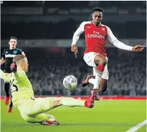  ?? Picture: GETTY IMAGES ?? TAKING OFF: Arsenal’s Danny Welbeck, right, is challenged by West Ham United goalkeeper Joe Hart during their League Cup quarterfin­al match at Emirates Stadium on Tuesday in London. Arsenal advanced to the semifinals after Welbeck netted the solitary...