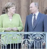  ??  ?? German Chancellor Angela Merkel (left), welcomes the President of Russia Vladimir Putin for a meeting at the government guest house near Berlin, Germany, yesterday.