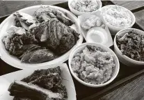  ?? Mike Sutter / Staff file photo ?? A Family Pack sampler from Big Bib BBQ includes all the meats and two sides, shown here with two extra sides and a half-pound of baby back ribs. The barbecue spot is among those participat­ing in Black Restaurant Week San Antonio.