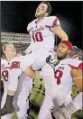  ?? Arkansas Democrat- Gazette fi le photo ?? Quarterbac­k Brandon Allen is carried off the field by teammates after his two- point conversion in overtime pushed Arkansas to a comeback victory over Mississipp­i.