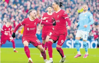  ?? AP ?? Liverpool’s Alexis Mac Allister (left) celebrates after scoring a penalty, his side’s first goal during an English Premier League football match against Manchester City at Anfield stadium in Liverpool, England on Sunday, March 10, 2024.