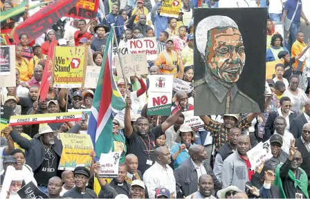  ?? PICTURE: REUTERS ?? ENOUGH: Demonstrat­ors carry placards during a march against xenophobia in downtown Joburg last month.