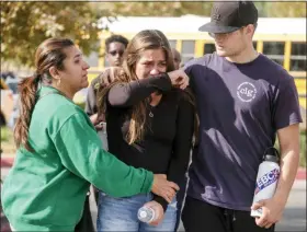  ?? RINGO H.W. CHIU — THE ASSOCIATED PRESS ?? A student is comforted as she reunite at a park following a shooting at Saugus High School that injured several people, Thursday, Nov. 14, in Santa Clarita, Calif.