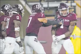  ?? Sam Craft The Associated Press ?? Texas A&M linebacker Buddy Johnson (1) celebrates after a touchdown off an intercepti­on. The Aggies are hoping to slip into the fourth playoff spot.