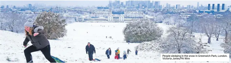  ?? ?? People sledging in the snow in Greenwich Park, London. Victoria Jones/pa Wire