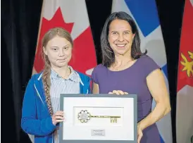  ?? /Reuters ?? Turning tides: Climate change activist Greta Thunberg receives the key to the city from Montreal mayor Valerie Plante after a climate strike march in Montreal, Canada, last week.