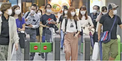  ?? Photo: AP ?? Rail passengers at Yokohama station. People in Japan began to wear masks back in February.