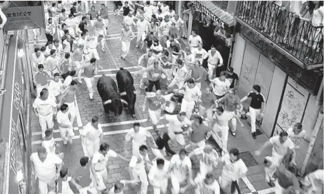  ?? RICK STEVES ?? The Running of the Bulls takes place annually in Pamplona, Spain.