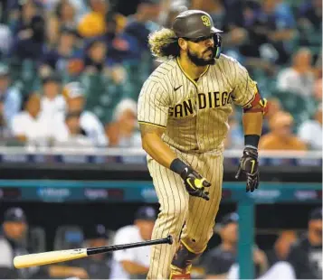  ?? PHOTOS BY DUANE BURLESON AP ?? Padres’ Jorge Alfaro singles to drive in two runs in the 10th inning against the Tigers on Tuesday in Detroit. The catcher also drove in a run in the third inning with a ground-rule double to center field.