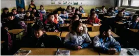  ?? BRYAN DENTON /THE NEW YORK TIMES ?? Second-graders attend class in southern Beijing in December 2017. China is considerin­g removing its controvers­ial state-sanctioned limits on the number of children that a family can have. The country’s rapidly aging population will have broad...