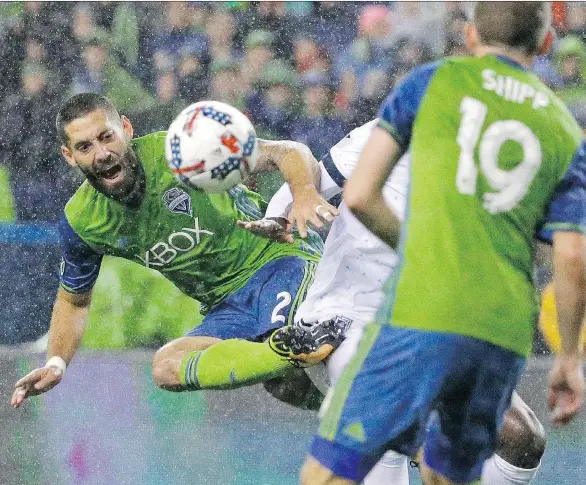  ?? PHOTOS: TED S. WARREN/ THE ASSOCIATED PRESS ?? Seattle Sounders forward Clint Dempsey kicks the ball away from Caps midfielder Aly Ghazal during Seattle’s 2- 0 win Thursday in Seattle.