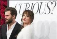  ??  ?? Jamie Dornan and Dakota Johnson attend a special fan screening of “Fifty Shades of Grey” at the Ziegfeld Theatre on Friday in New York City.