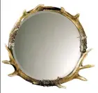  ?? LAMPS PLUS/UTTERMOST VIA AP ?? The mirror is framed with acrylic stag horns. Elements like these add drama and interest to any room style, and don't overtly reference the holidays.