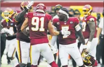  ?? DANIEL KUCIN JR. — THE ASSOCIATED PRESS ?? Washington Football Team quarterbac­k Dwayne Haskins Jr. (7) celebrates with his teammates after a huge defensive stop against the Philadelph­ia Eagles, Sunday, in Landover, Md.