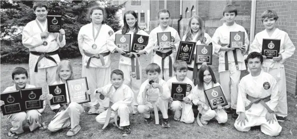  ?? [ELENA MAYSTRUK / THE OBSERVER] ?? Elmira Karate Dojo students swept away a national competitio­n in Elora April 14. Back row: Michael Hewitt, Raven Fockler, Leah Shillingto­n, Emily Hickey, Taylor Payne, Aiden Prentice, Nathan Maier. Front row: Anson Willoughby, Lauren Hickey, Jaxon...