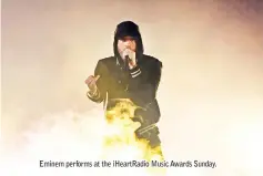  ??  ?? Eminem performs at the iHeartRadi­o Music Awards Sunday.