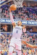  ?? NICK WASS/ASSOCIATED PRESS ?? Oklahoma City’s Russell Westbrook (0) goes past Washington’s Bradley Beal for a basket during Friday’s game.