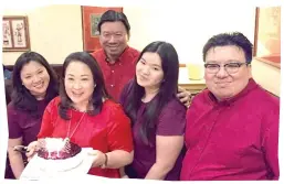  ??  ?? BIRTHDAY GIRL. Angelita "Baby" Dy with her cake flanked by daughters Ann and Angela. At right is son Lloyd and at the back is husband Nelson.