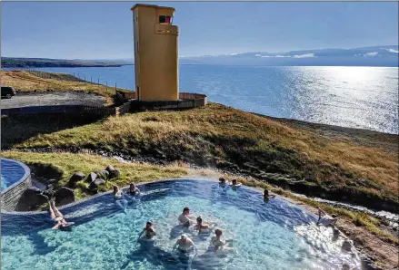  ?? 104-degree seawater pumped into a broad infinity pool with PHOTOS BY SIMON PETER GROEBNER/MINNEAPOLI­S STAR TRIBUNE ?? Geosea Geothermal Sea Baths, in the whale-watching capital of Husavik, features a sprawling view of mountains and the Greenland Sea.