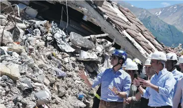  ?? EMILIANO GRILLOTTI / AFP / GETTY IMAGES ?? Prime Minister Justin Trudeau listens to Italy’s Foreign Affairs Minister Angelino Alfano during a visit to Amatrice, Italy, a medieval town that was destroyed in an earthquake last August.