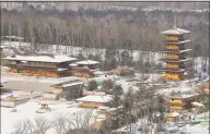  ?? Julie Jacobson / Associated Press ?? This March 8 photo shows the Falun Gong Dragon Springs compound in Otisville, N.Y. After years of additions, the lakeside site features Tang Dynasty-style buildings close by modern, boxy buildings that would fit into a contempora­ry office park. Dragon Springs said 100 people, mostly students, live there.