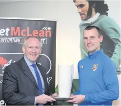  ??  ?? Top boss: Paul McLean presents Coleraine’s Oran Kearney with the BetMcLean Manager of the Month award for September