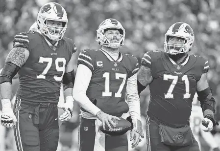  ?? TIMOTHY T LUDWIG/ GETTY IMAGES ?? From left, Bills offensive tackle Spencer Brown, Josh Allen and center/ guard Ryan Bates look on against the Dolphins during the second half.