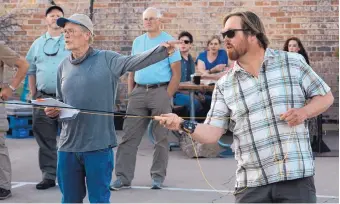  ?? GREG SORBER/JOURNAL ?? Veteran fishing guide Taylor Streit, left, makes some observatio­ns while his son Nick gives a casting demonstrat­ion Thursday at Rio Bravo Brewery.