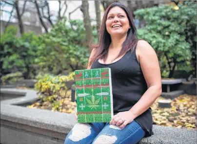  ?? CP PHOTO ?? Lorilee Fedler, owner of Coast to Coast Medicinals, is pictured with her cannabis Christmas calendars in Vancouver, B.C., on Saturday. A Vancouver cannabis company is scrambling to keep up with a flood of orders for marijuana-filled advent calendars,...